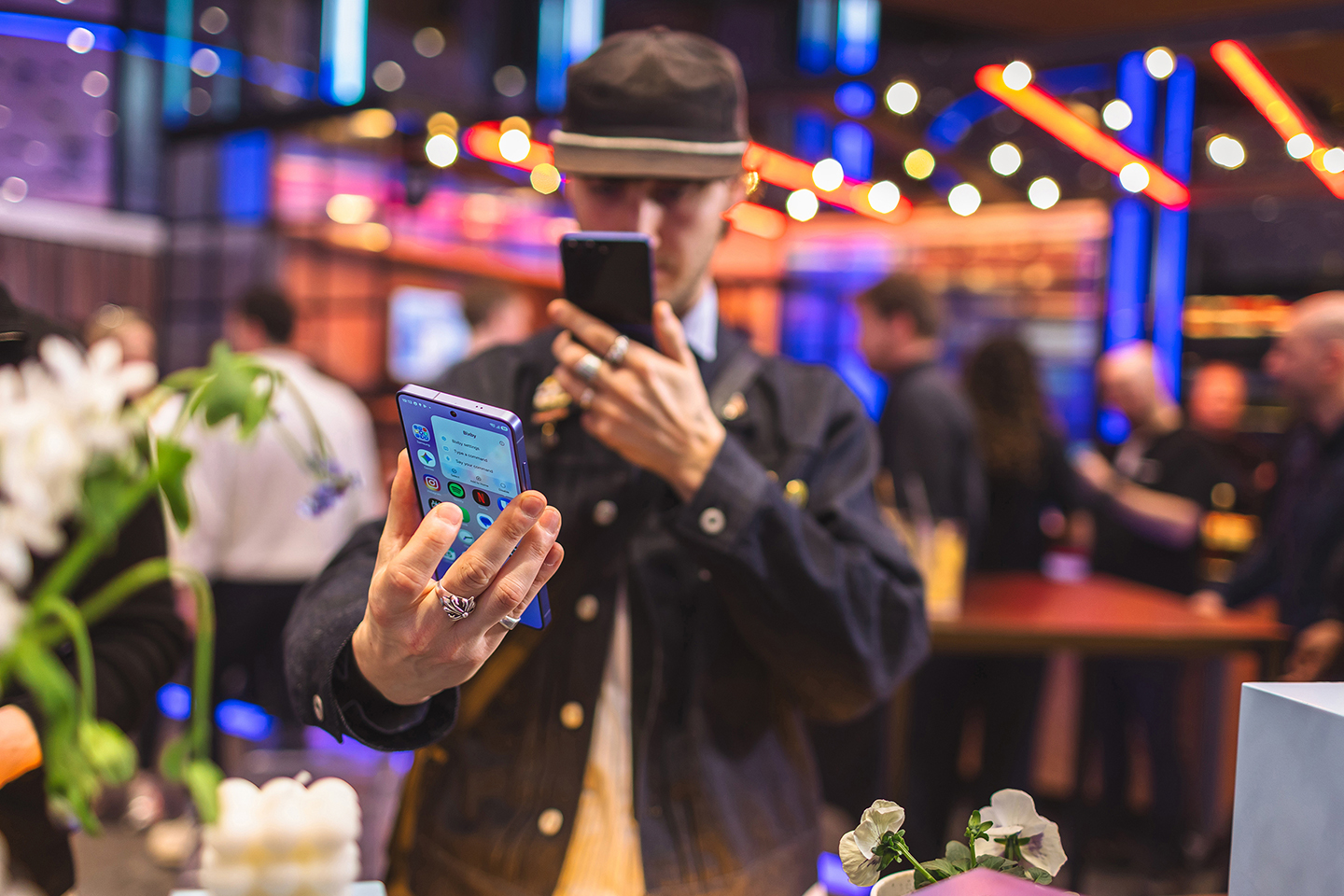 A person takes a photo of the back of a Galaxy S26 device.