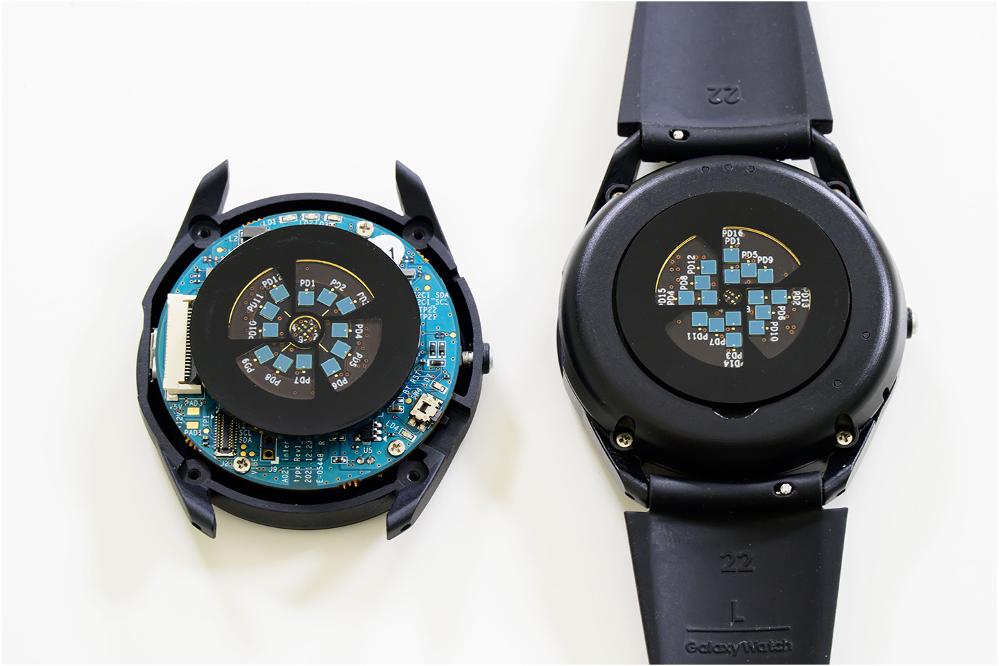 Two Galaxy Watch8’s placed side by side, featuring LED-PD prototype testbeds. 