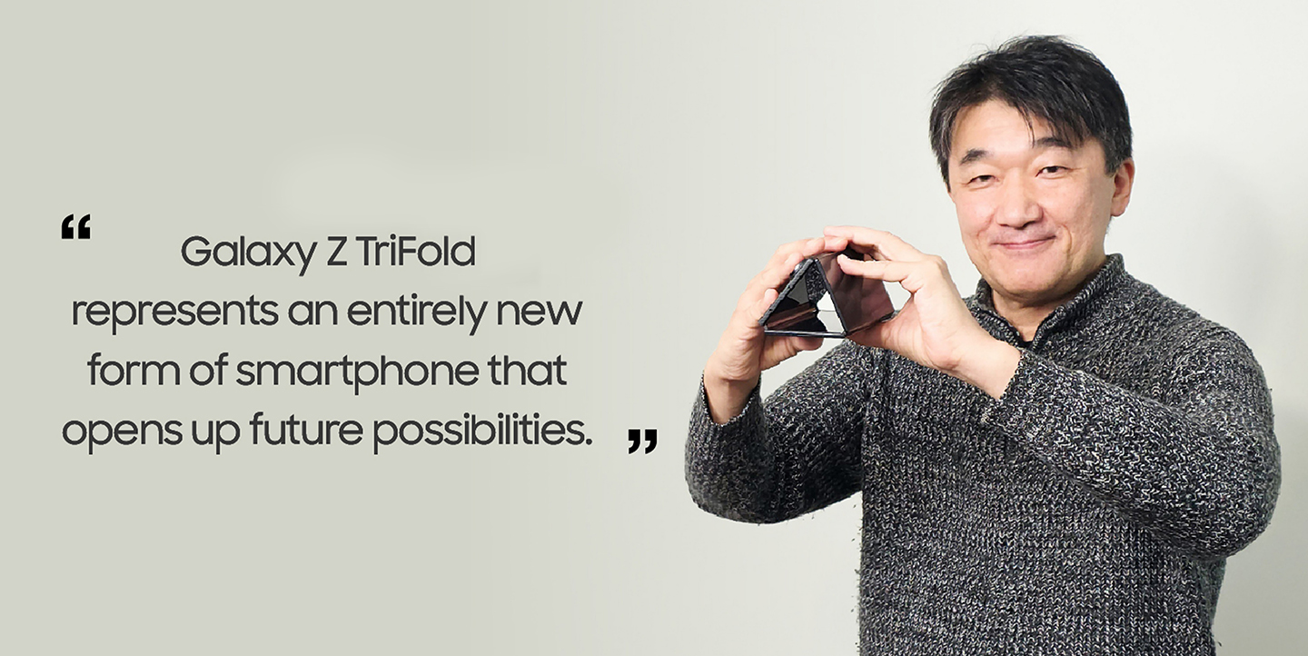 Yasuhiro Yamane holds Galaxy Z TriFold folded into a triangular shape, with a quote beside him that reads, “Galaxy Z TriFold represents an entirely new form of smartphone that opens up future possibilities.” 