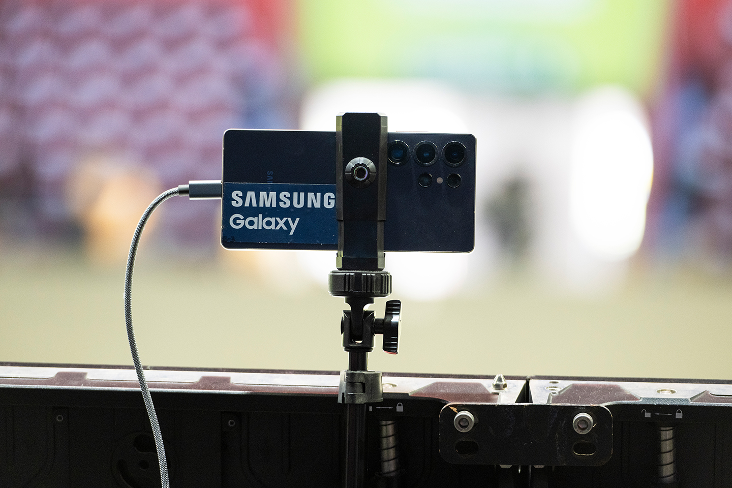 The back face of a Galaxy S25 mounted near the SLS Super Crown World Championship stage.