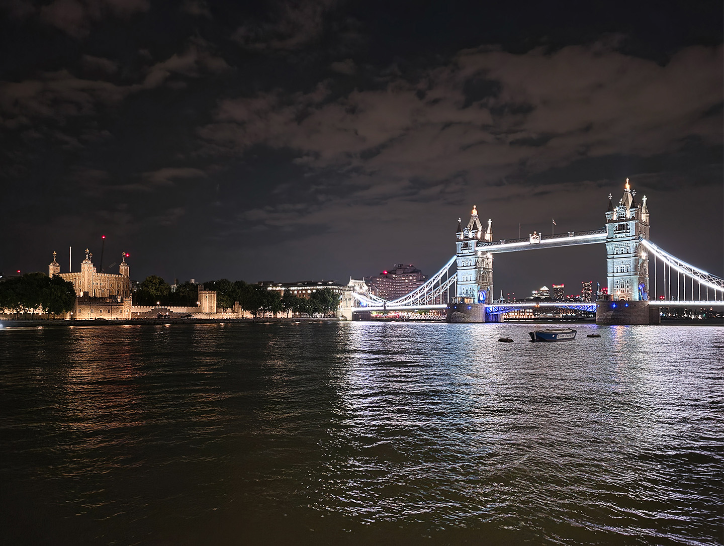Photo of Tower Bridge taken with Galaxy Z Fold8 Ultra's enhanced Nightography, with the illuminated bridge and Thames River visible in the background under moonlight in London. 