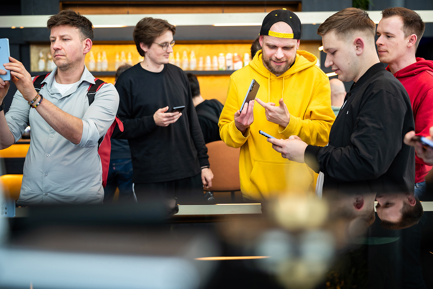 Various people holding Galaxy S26 series devices while exploring the new devices.